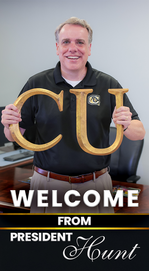 CU President Shane Hunt holding big gold colored C U letters
